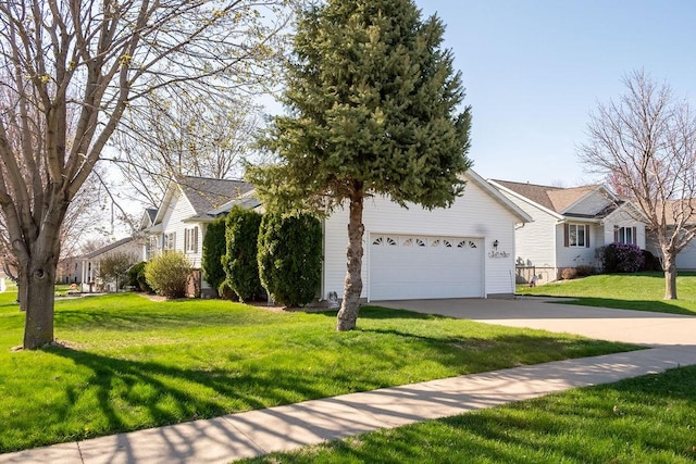view of front of property with concrete driveway, a front yard, and an attached garage