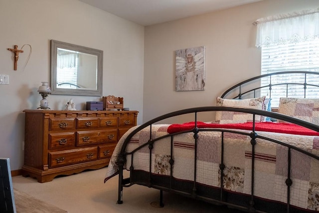 bedroom featuring light carpet