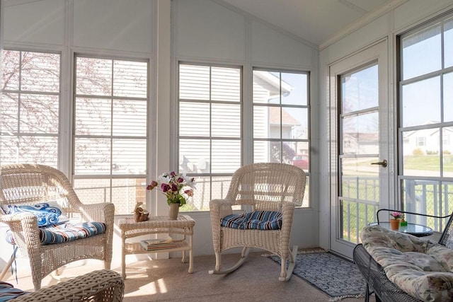 sunroom / solarium with crown molding, carpet, vaulted ceiling, and a wealth of natural light