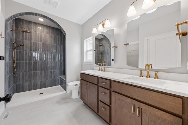 1089 Archer Dr, Marion, IA 52302 - bathroom featuring double vanity, tiled shower, a sink, and visible vents