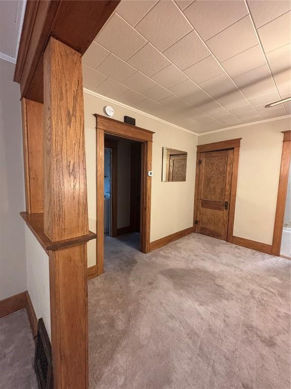 832 Daniels St NE, Cedar Rapids, IA 52402 - carpeted spare room featuring crown molding, baseboards, and a smoke detector