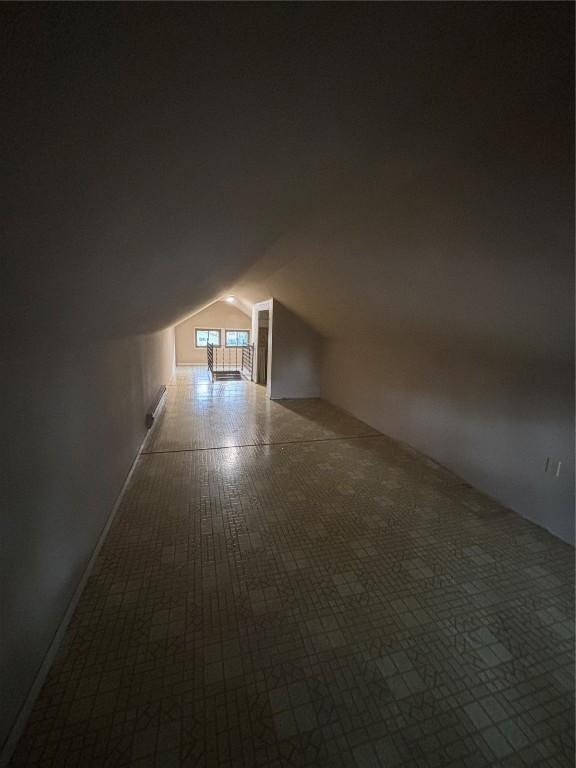 832 Daniels St NE, Cedar Rapids, IA 52402 - additional living space with lofted ceiling and carpet
