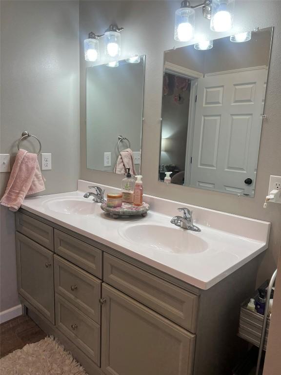 bathroom featuring a sink and double vanity