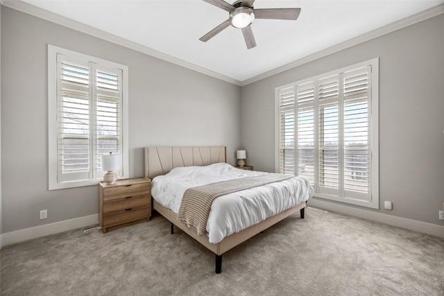 carpeted bedroom with ceiling fan, baseboards, and ornamental molding