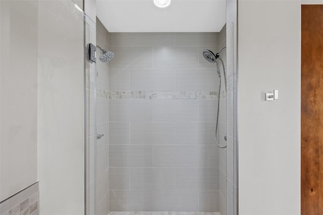 full bath with a tile shower