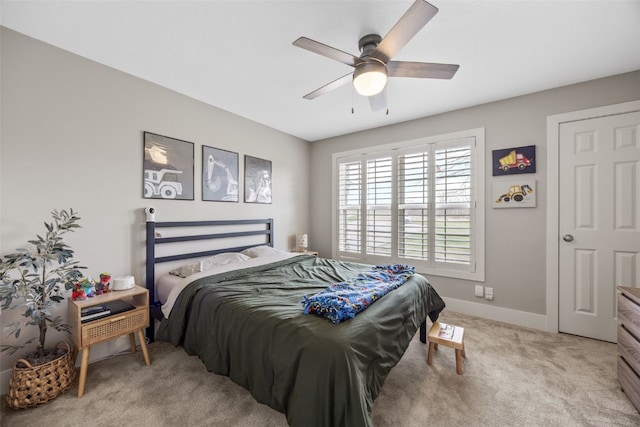bedroom with baseboards, light colored carpet, and ceiling fan