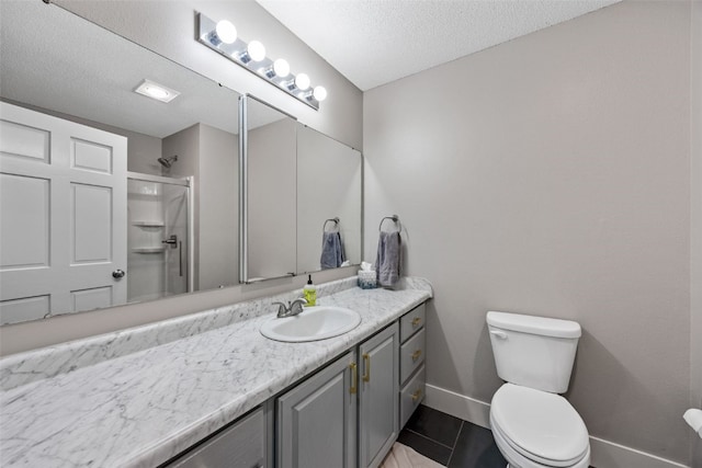full bath featuring vanity, baseboards, a textured ceiling, toilet, and a shower