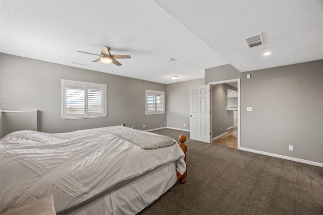bedroom featuring visible vents, baseboards, carpet flooring, and a textured ceiling