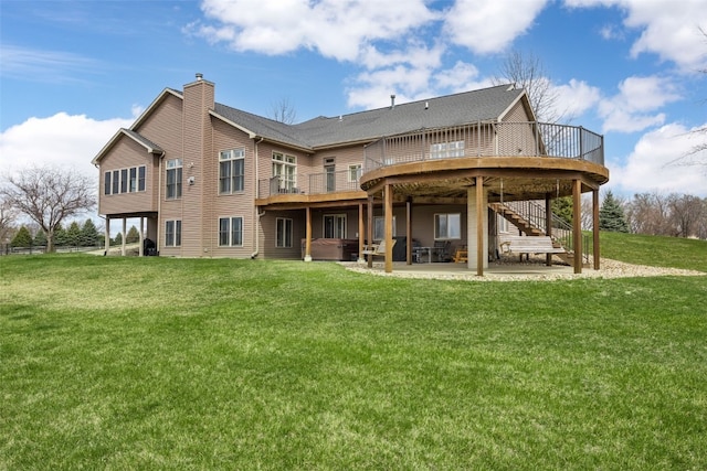 rear view of house featuring a yard, a patio area, stairs, a chimney, and a deck