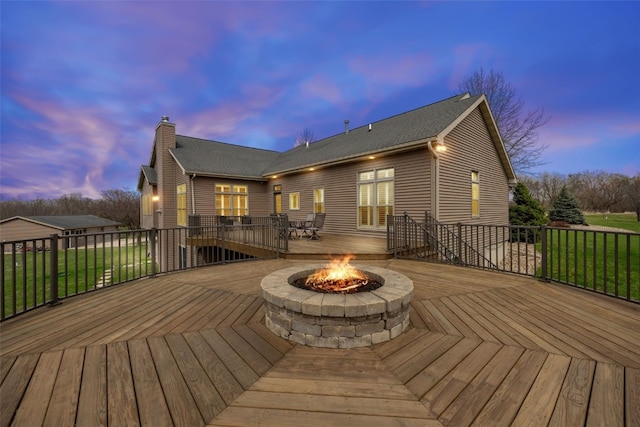 wooden terrace with an outdoor fire pit