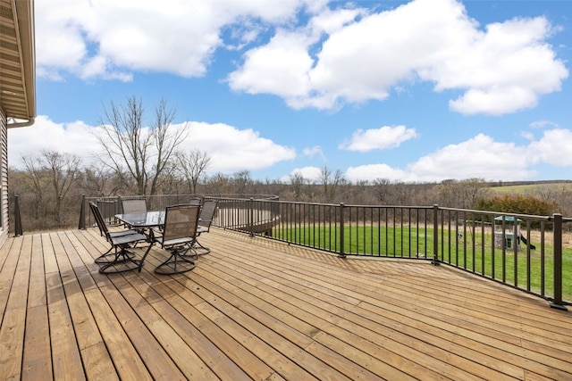 deck featuring a yard and outdoor dining space