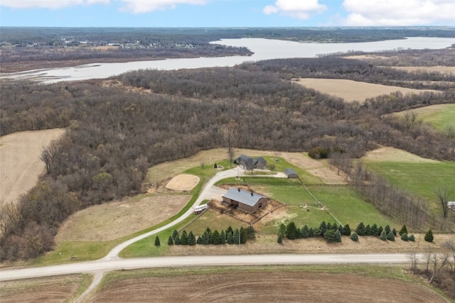 bird's eye view with a water view and a wooded view