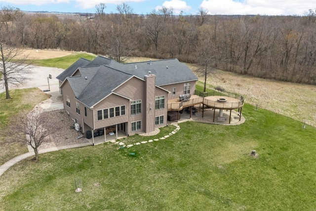 drone / aerial view with a wooded view