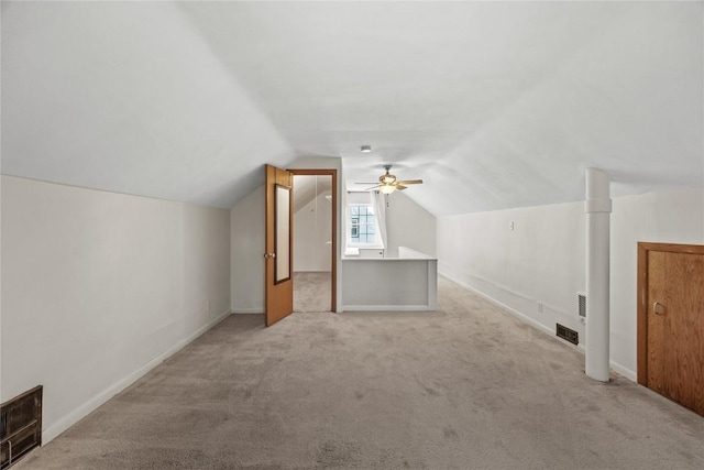 additional living space featuring visible vents, carpet floors, and vaulted ceiling