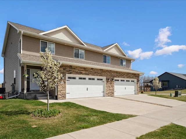 view of front of house with driveway, stone siding, an attached garage, and a front lawn