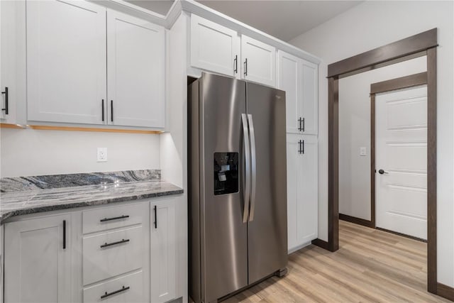 1232 Berkshire Ln, North Liberty, IA 52317 - kitchen with stainless steel fridge, light wood-type flooring, white cabinets, stone countertops, and baseboards