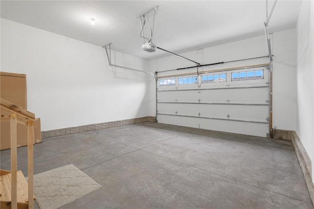 1232 Berkshire Ln, North Liberty, IA 52317 - garage with a garage door opener and baseboards