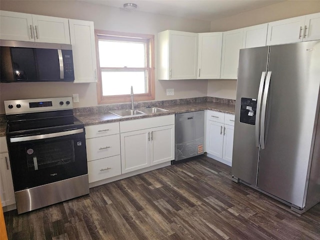 2704 Otis Rd SE, Cedar Rapids, IA 52403 - kitchen featuring appliances with stainless steel finishes, a sink, dark wood-style floors, and white cabinetry