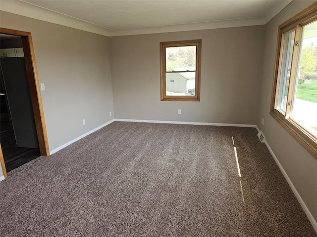 2704 Otis Rd SE, Cedar Rapids, IA 52403 - carpeted spare room featuring plenty of natural light, baseboards, and crown molding