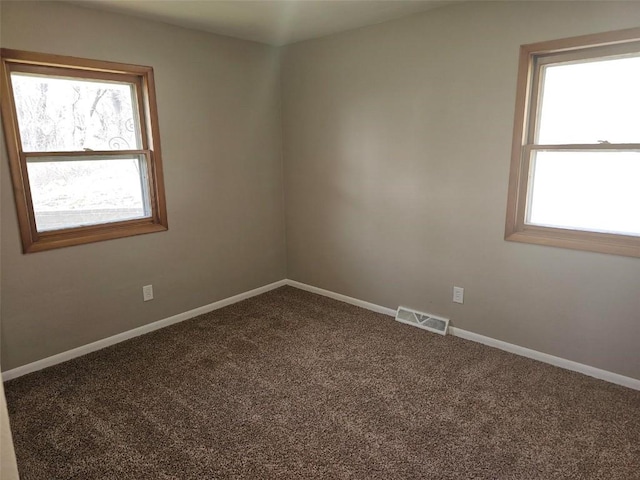 2704 Otis Rd SE, Cedar Rapids, IA 52403 - empty room with plenty of natural light, carpet flooring, and baseboards