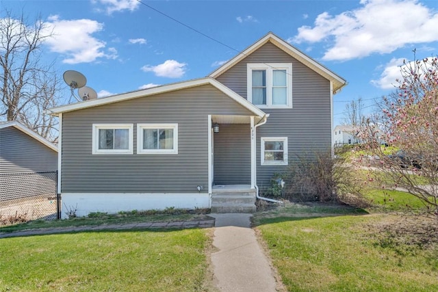 bungalow-style home featuring a front lawn