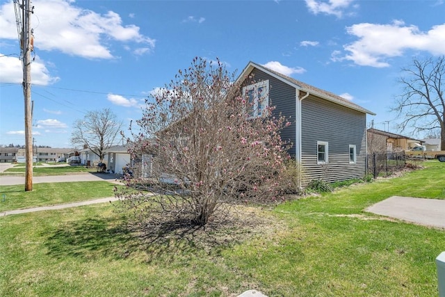 view of home's exterior featuring a yard, a garage, and concrete driveway