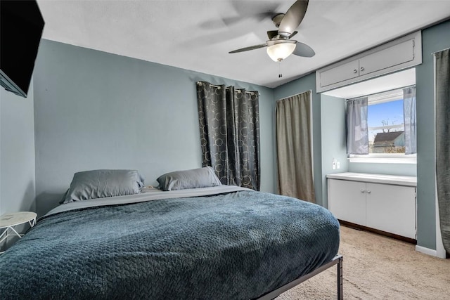 bedroom featuring light carpet, ceiling fan, and baseboards