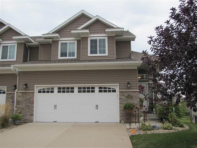 1785 Sara Ct, North Liberty, IA 52317 - craftsman inspired home with a garage, stone siding, and concrete driveway