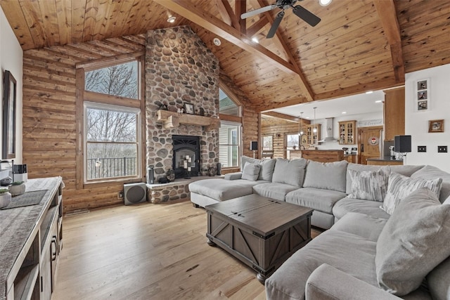 living room featuring wood ceiling, plenty of natural light, light wood-style floors, and high vaulted ceiling
