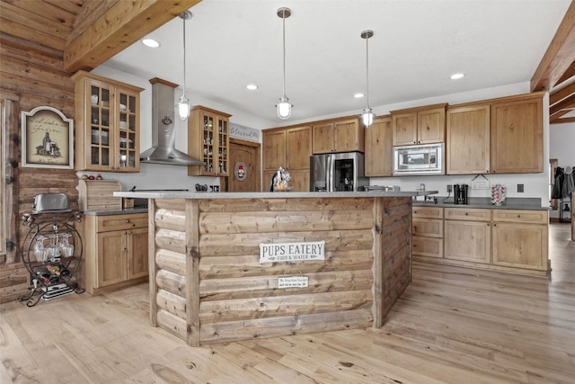 kitchen featuring a center island, appliances with stainless steel finishes, light wood finished floors, and recessed lighting