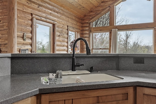 interior details featuring wooden ceiling, brown cabinets, tasteful backsplash, and a sink