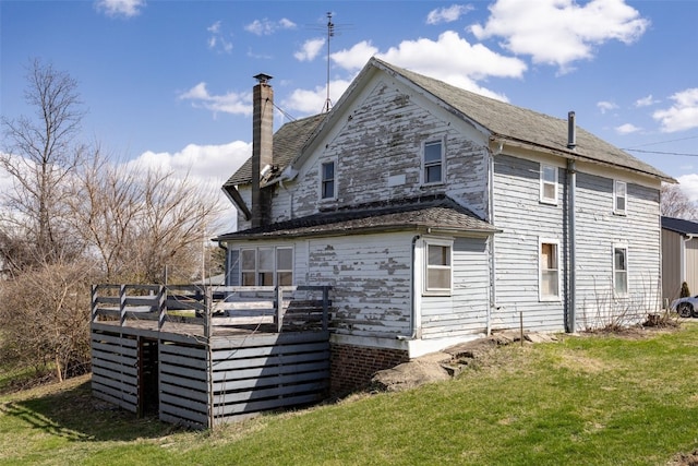 408 W Green St, Wyoming, IA 52362 - rear view of house with a lawn, a chimney, and a deck