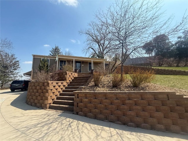 ranch-style home with stairway and driveway