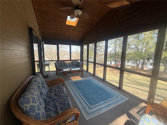 sunroom / solarium featuring a ceiling fan, lofted ceiling, outdoor lounge area, and a skylight