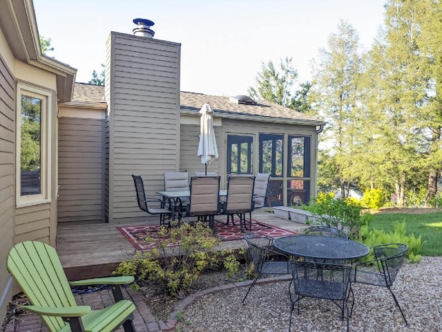 view of patio with outdoor dining area and a deck