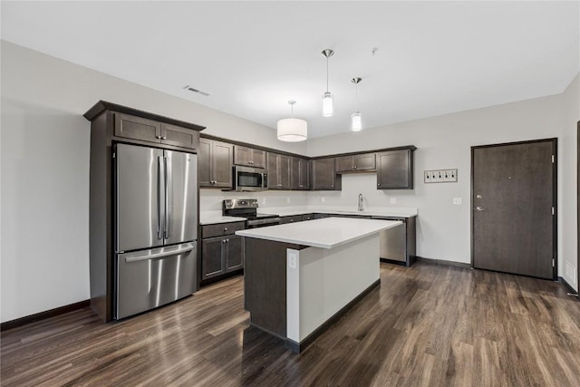 2873 Spring Rose Cir Unit 206, Coralville, IA 52241 - kitchen featuring stainless steel appliances, dark wood-style flooring, dark brown cabinetry, light countertops, and a center island