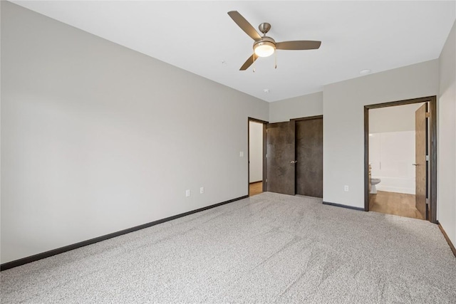 2873 Spring Rose Cir Unit 206, Coralville, IA 52241 - unfurnished bedroom featuring carpet floors, connected bathroom, a closet, and ceiling fan