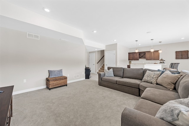 919 Camp Cardinal Rd, Iowa City, IA 52246 - living area with light carpet, stairs, visible vents, and recessed lighting