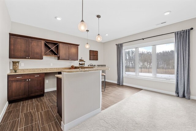 919 Camp Cardinal Rd, Iowa City, IA 52246 - kitchen featuring dark brown cabinets, baseboards, visible vents, pendant lighting, and open shelves
