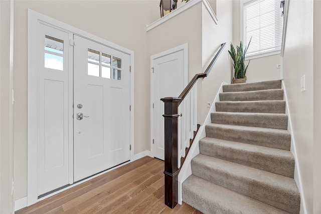 919 Camp Cardinal Rd, Iowa City, IA 52246 - foyer with light wood finished floors, baseboards, and stairs