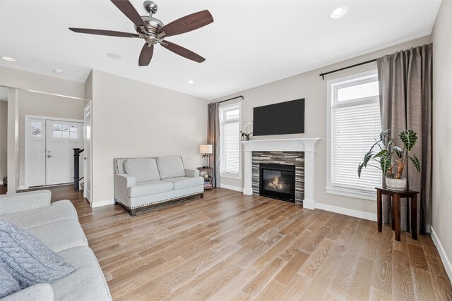 919 Camp Cardinal Rd, Iowa City, IA 52246 - living area with recessed lighting, light wood finished floors, a ceiling fan, baseboards, and a tiled fireplace