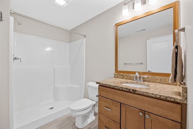 919 Camp Cardinal Rd, Iowa City, IA 52246 - bathroom featuring a shower, toilet, vanity, and visible vents