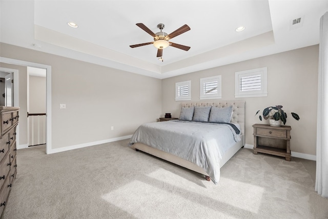 919 Camp Cardinal Rd, Iowa City, IA 52246 - bedroom featuring a tray ceiling, baseboards, visible vents, and light colored carpet