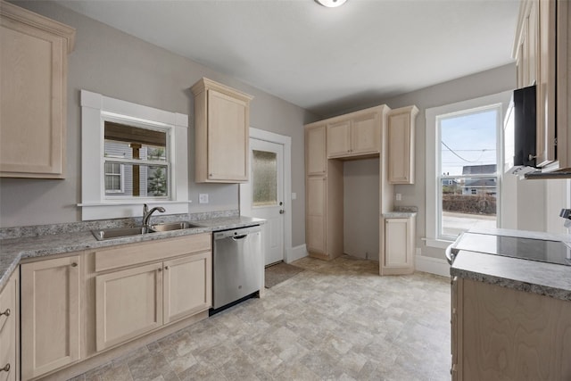 kitchen with stainless steel dishwasher, light brown cabinets, a sink, baseboards, and light countertops