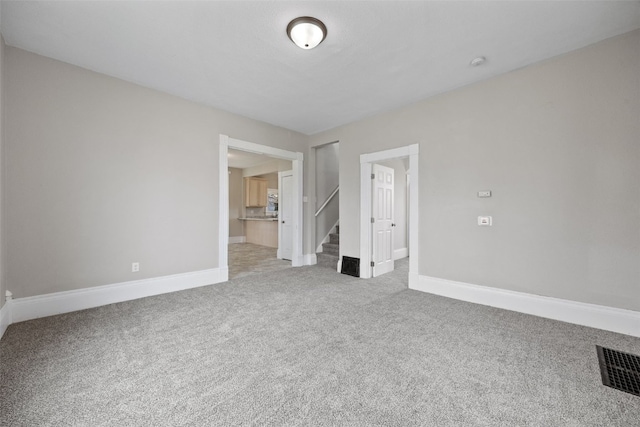 unfurnished bedroom with light carpet, baseboards, and connected bathroom