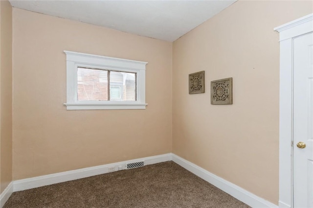 carpeted empty room with visible vents and baseboards