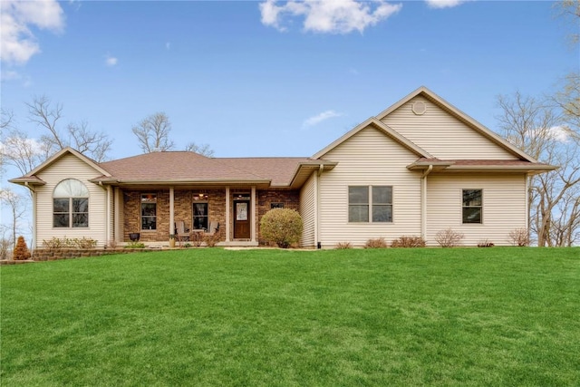 ranch-style house with a front yard, covered porch, and roof with shingles