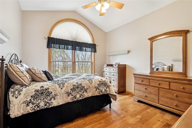 bedroom featuring lofted ceiling, light wood-style floors, and ceiling fan
