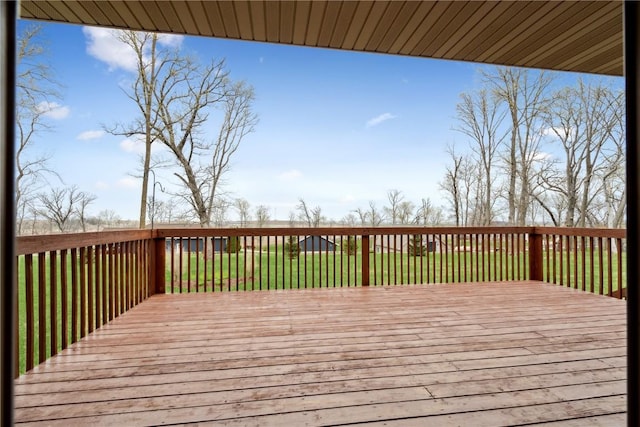 wooden terrace featuring a yard