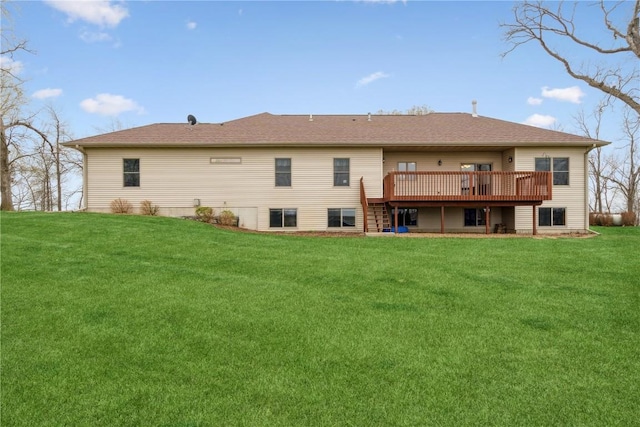 rear view of property with a wooden deck and a lawn